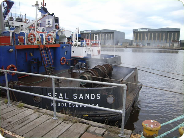 Water jetting to clean ship hull in a dry dock